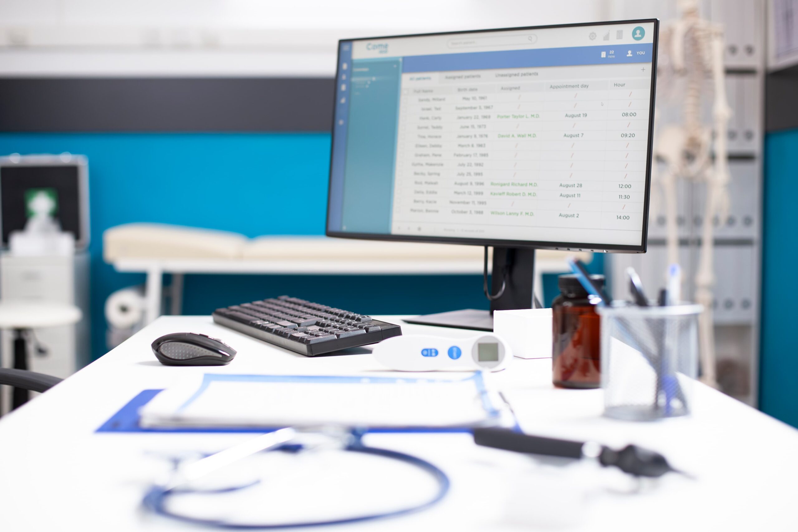 Physical therapy clinic reception desk with patient scheduling software and EMR system